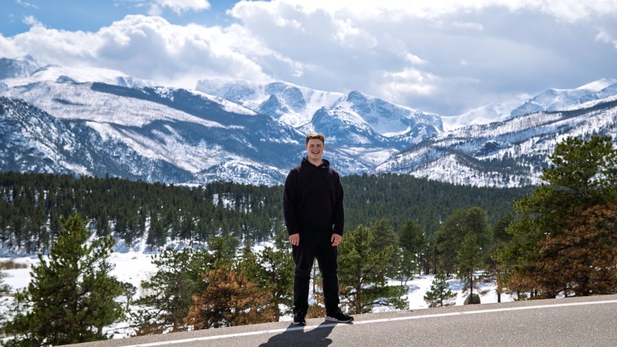 Colton Kareck in front of snow-capped mountains