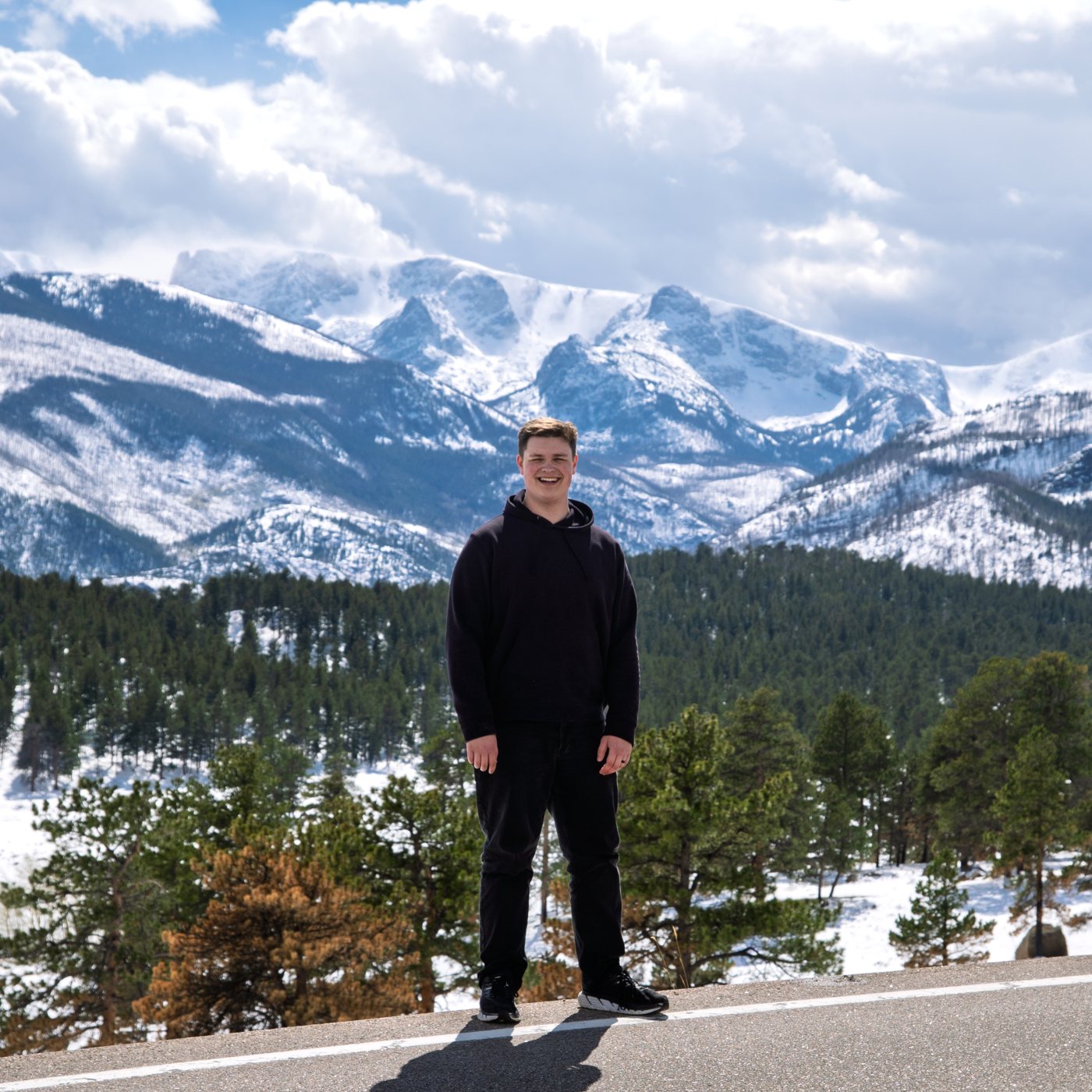 Colton Kareck in front of snow-capped mountains