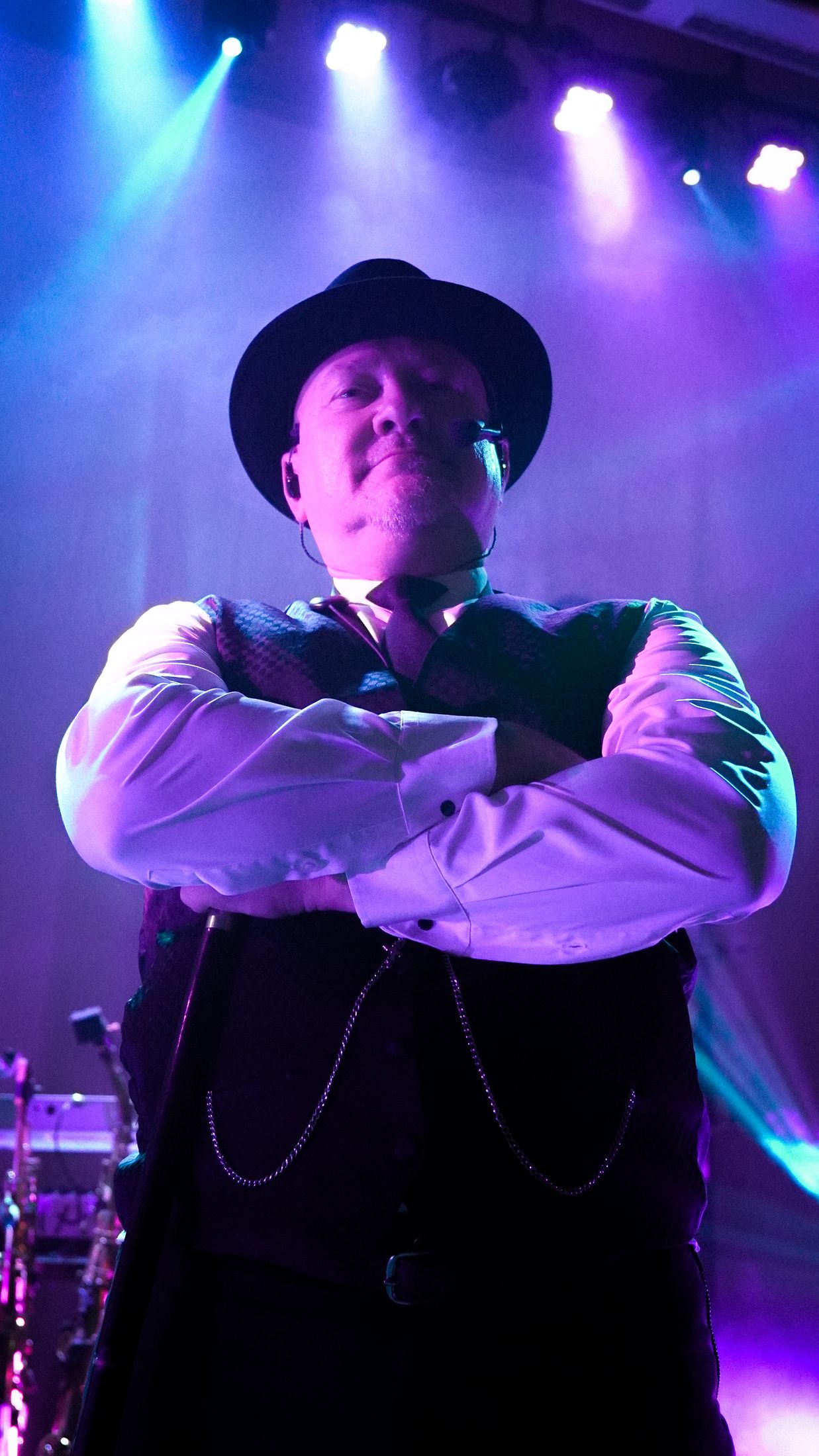 Jeffrey Scot Wills, arms crossed on stage